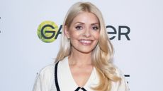 Holly Willoughby smiles as she attends a pub quiz hosted by Garnier