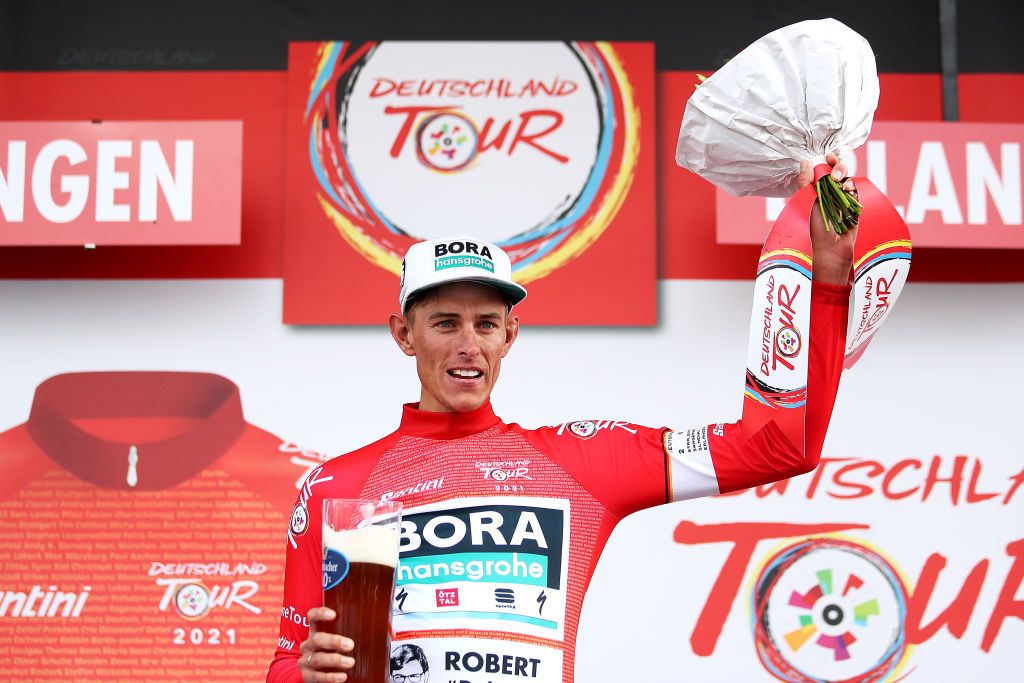 ERLANGEN GERMANY AUGUST 28 Nils Politt of Germany and Team Bora Hansgrohe celebrates winning the red leader jersey on the podium ceremony after the 35th Deutschland Tour 2021 Stage 3 a 1933km stage from Ilmenau to Erlangen DeineTour on August 28 2021 in Erlangen Germany Photo by Christian KasparBartkeGetty Images