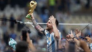 Argentina's Lionel Messi celebrating with the FIFA World Cup trophy in 2022