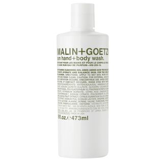 A white bottle Malin + Goetz hand and body wash with green text