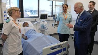 Britain's King Charles III speaks to students and trainees at the Intensive Care Ward as he visits the University of East London to mark the University's 125th anniversary and open a new frontline medical teaching hub in east London on February 8, 2023.