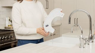 A woman emptying the water from her Meaco dehumidifier