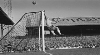 British footballer Gordon Banks (1937-2019), England goalkeeper, punches the ball clear of the cross bar as he makes a save during the 1963–64 British Home Championship match between England and Wales at Ninian Park in Cardiff, Wales, 12th October 1963. England won the match 4-0. (Photo by Evening Standard/Hulton Archive/Getty Images)