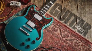 DâAngelico Premier Brighton electric guitar with an Ocean Turquoise finish on a wooden floor