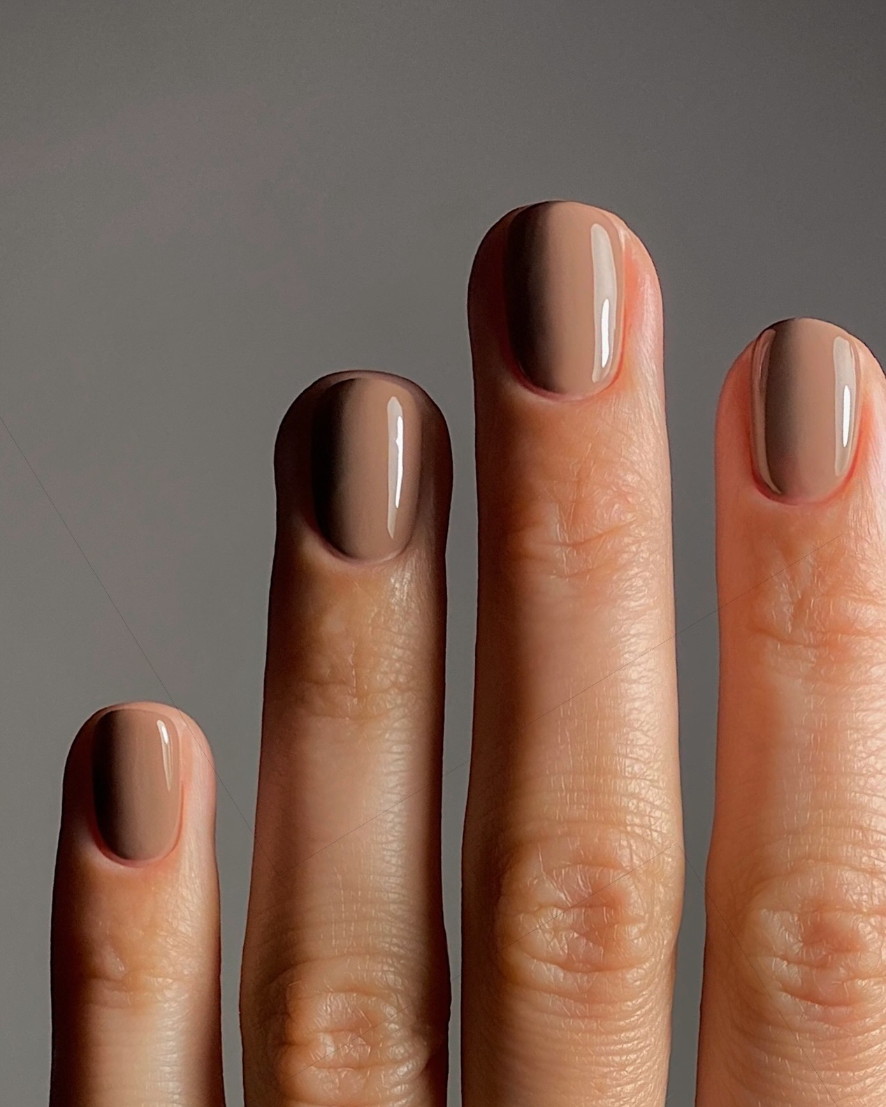 soft milky taupe nails, short and square with a muted neutral finish