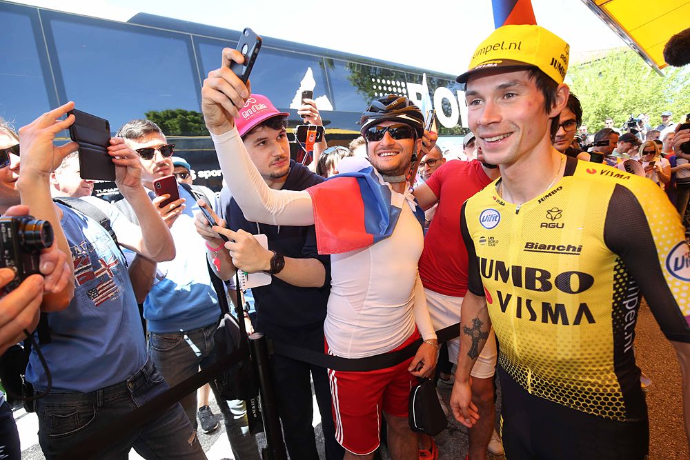 Primoz Roglic (Jumbo Visma) takes photos with fans at the start of stage 19 of the Giro d'Italia
