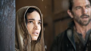 A hooded Kora stares at something in the distance in Rebel Moon on Netflix