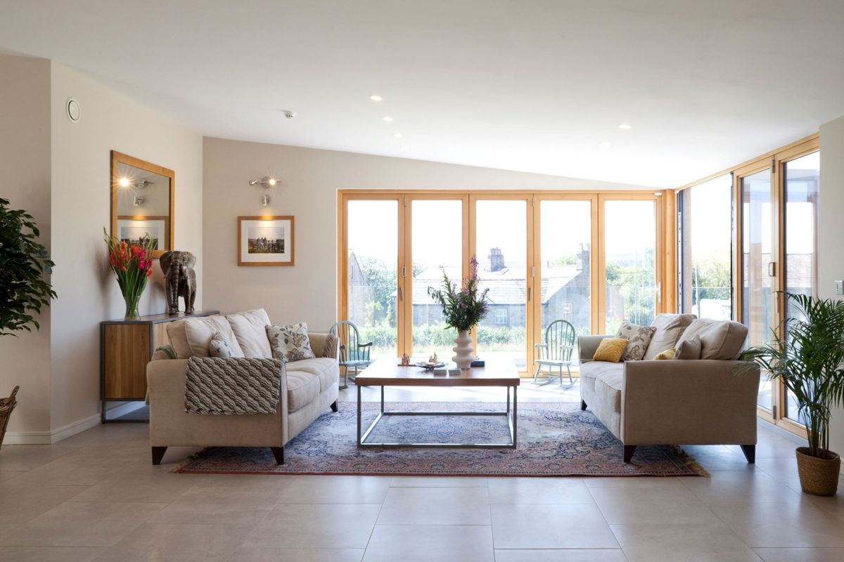 A neutral living room with sofas facing each other and a coffee table in the centre