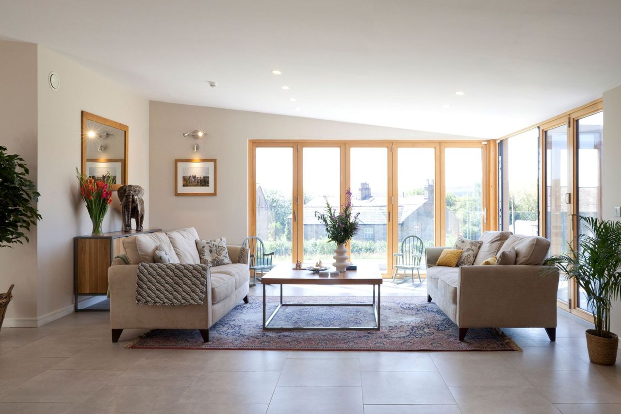A neutral living room with sofas facing each other and a coffee table in the centre