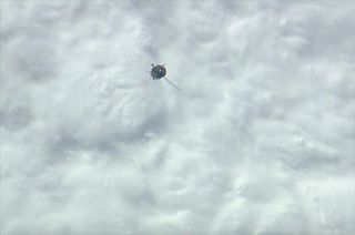 A Soyuz TMA-14M spacecraft, with only one of its two solar arrays deployed, is seen nearing the International Space Station on Sept. 25, 2014 (Eastern Time) to deliver three new members of the Expedition 41 crew.