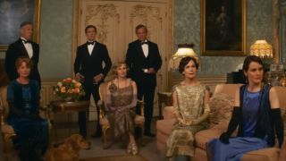 The cast of Downton Abbey: A New Era scattered around a beautifully decorated room.