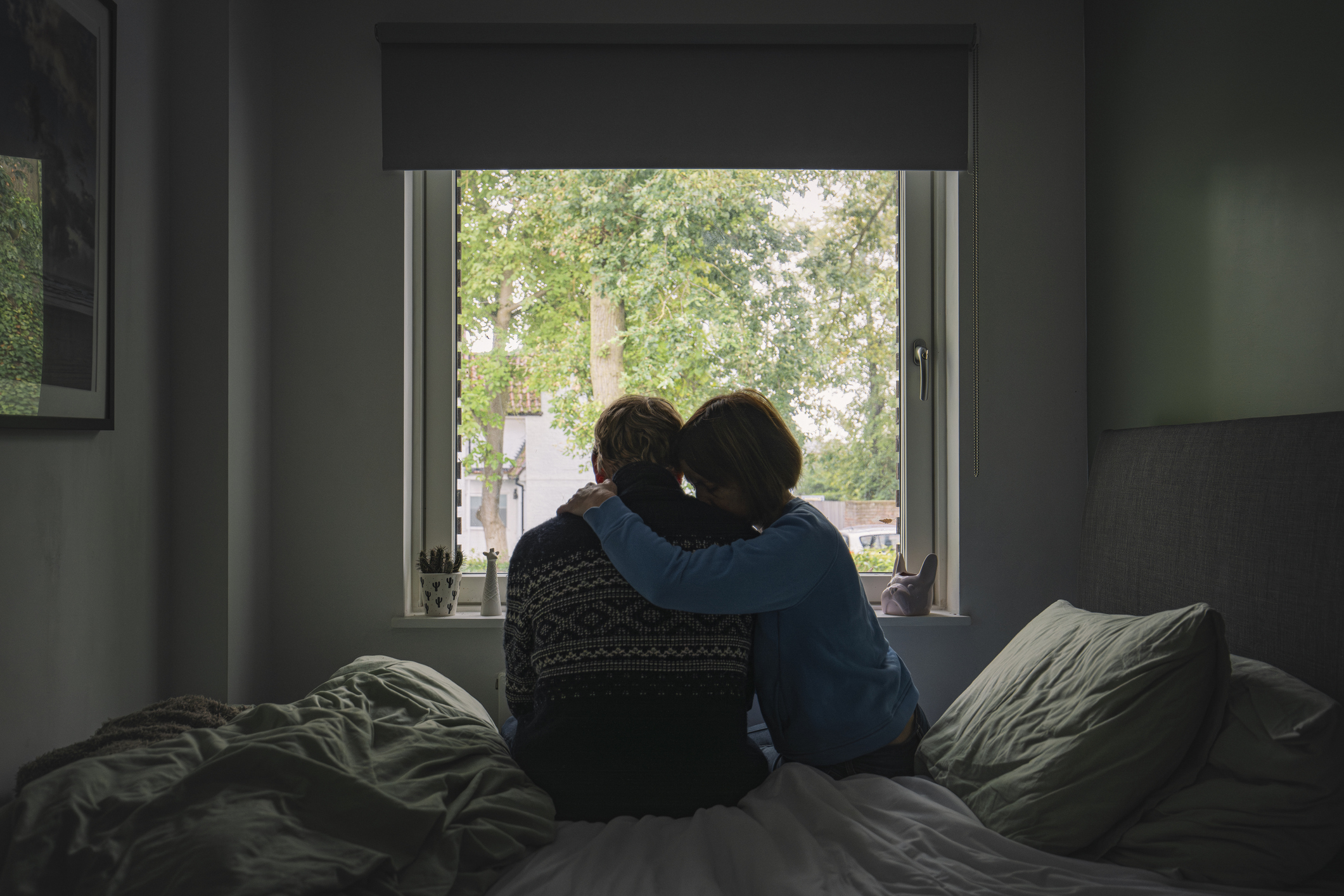 Cohabiting couple embracing in a bedroom 