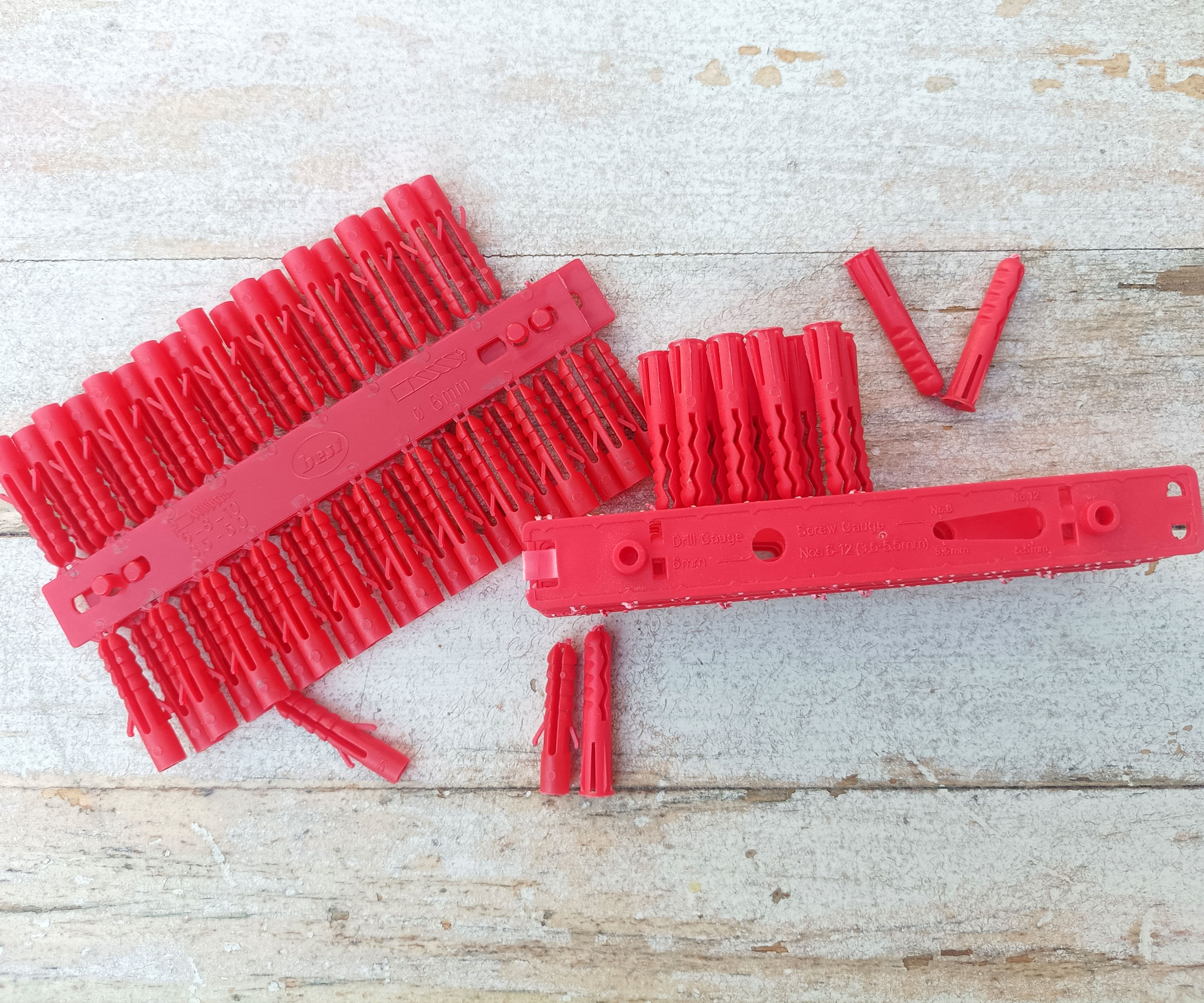 Red Rawl plugs on whitewashed wood