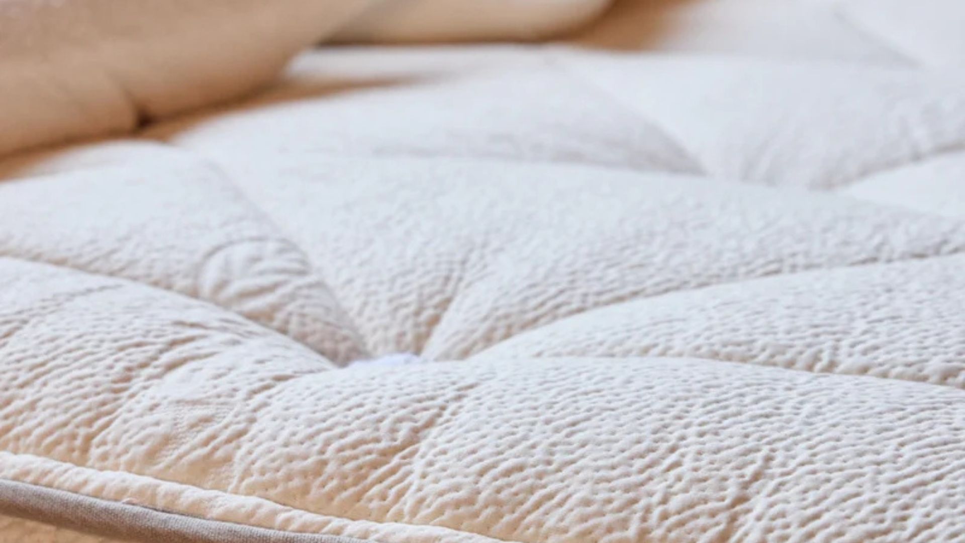 Close up of the cotton cover of the Avocado Wool mattress