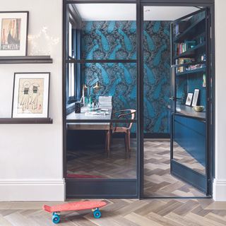 Home office layout in a separate room with black crittall doors.