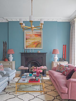 blue living room with pink sofa