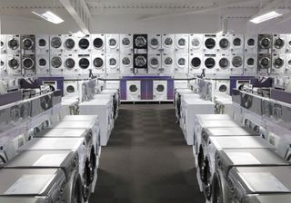 a photo of a store floor filled with white goods such as dishwashers, dryers and washing machines