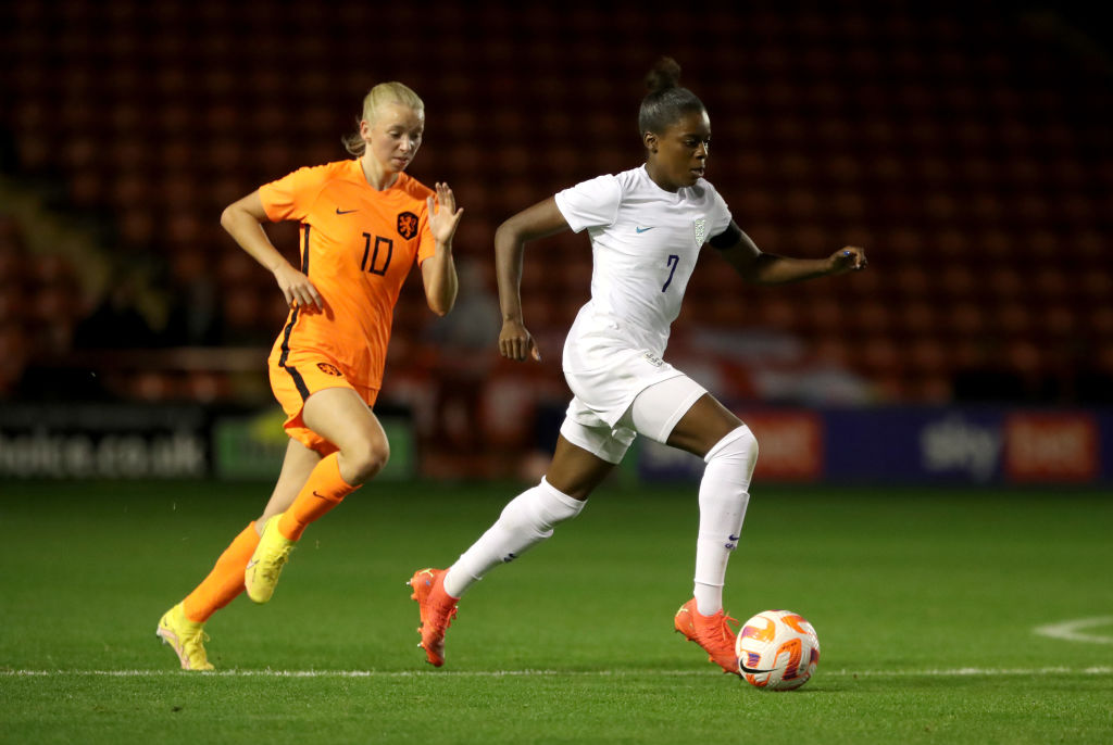 Jess Naz of England runs with the ball under pressure from Ella Peddemors of Netherlands during the WU23 International Friendly match between England Women and Netherlands Women at Poundland Bescot Stadium on November 10, 2022 in Walsall, England.