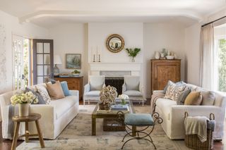 Neutral living room with cozy layers, textures, and artistic coffee table display