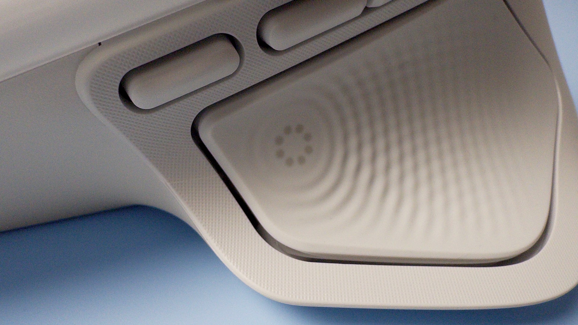 The Logitech MX Master 4 mouse against a blue background.