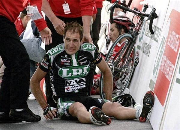 Spain's Ignac Gutierrez Cataluna (front) and Colombia's Leonardo Duque sit on the asphalt after crashing in the final yards of the race.