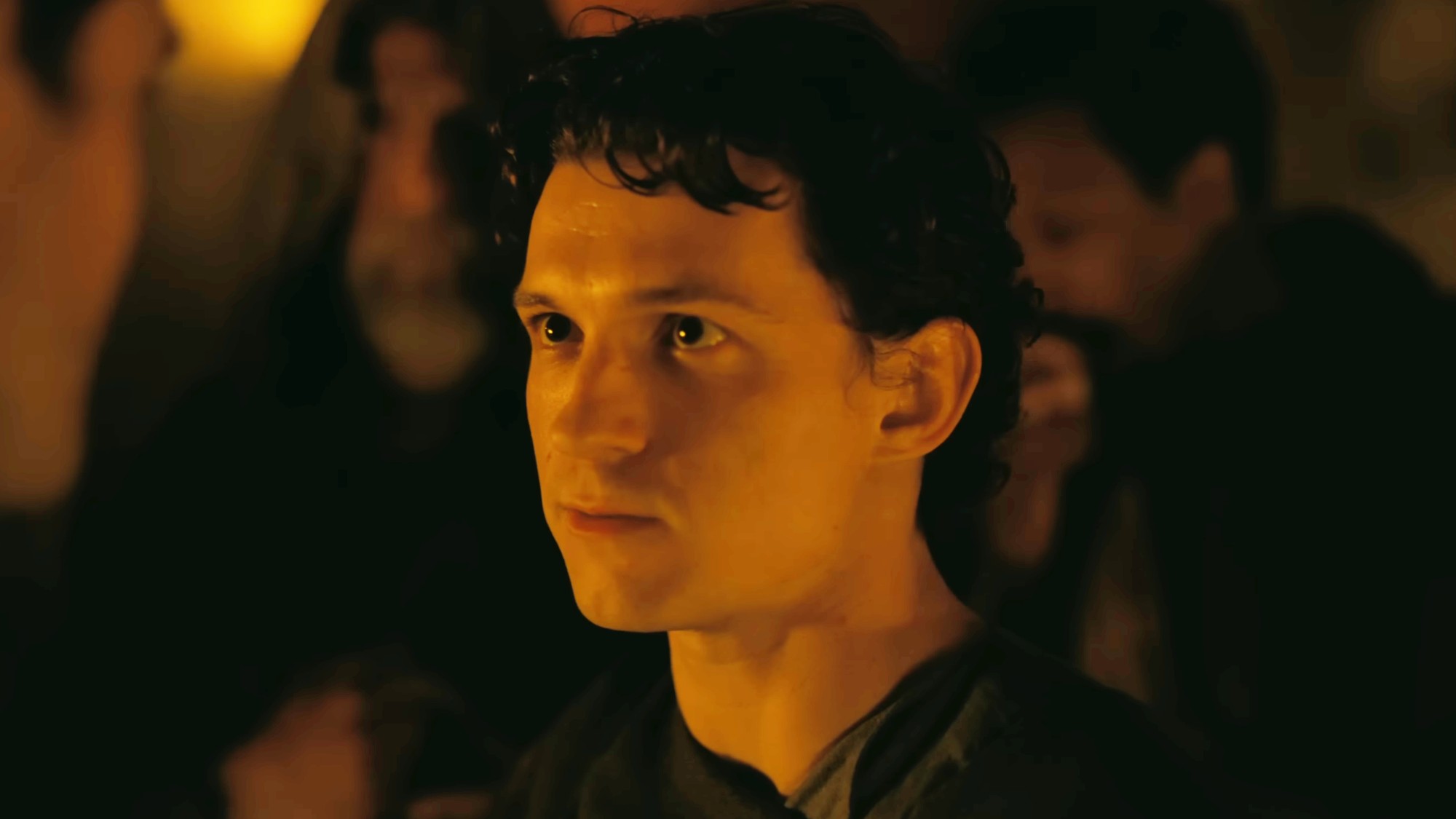 Tom Holland looking into the eyes of Robert Pattinson's character. 