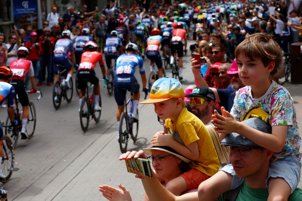 Riders go to the start of the 13th stage of the 107th Giro d'Italia cycling race, 179km between Riccione and Cento, on May 17, 2024. (Photo by Luca Bettini / AFP)