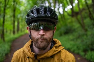 Model wears Oakley Kato Sunglasses in the forest