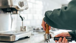 woman using espresso machine