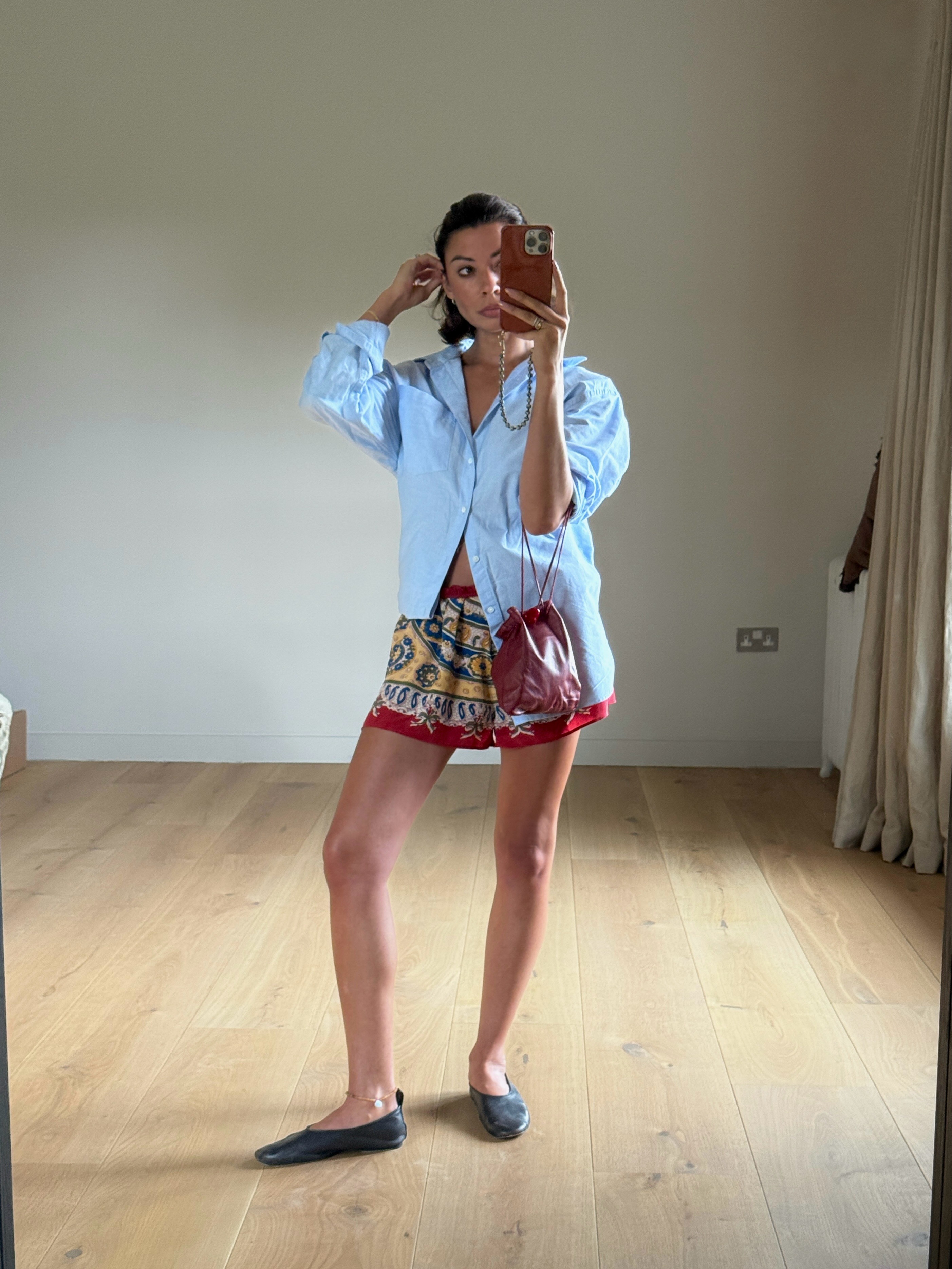 Marianne wearing linen shirt and shorts