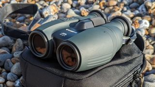 Front view of binoculars with pebbles behind