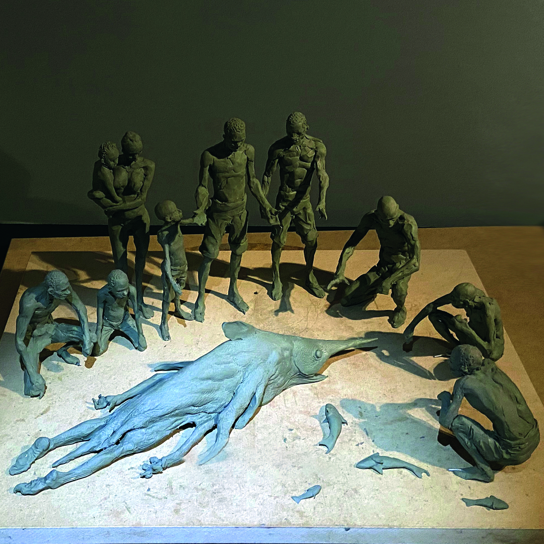 Sculptor Simon Lee; a sculpture of people standing around a fish-like creature