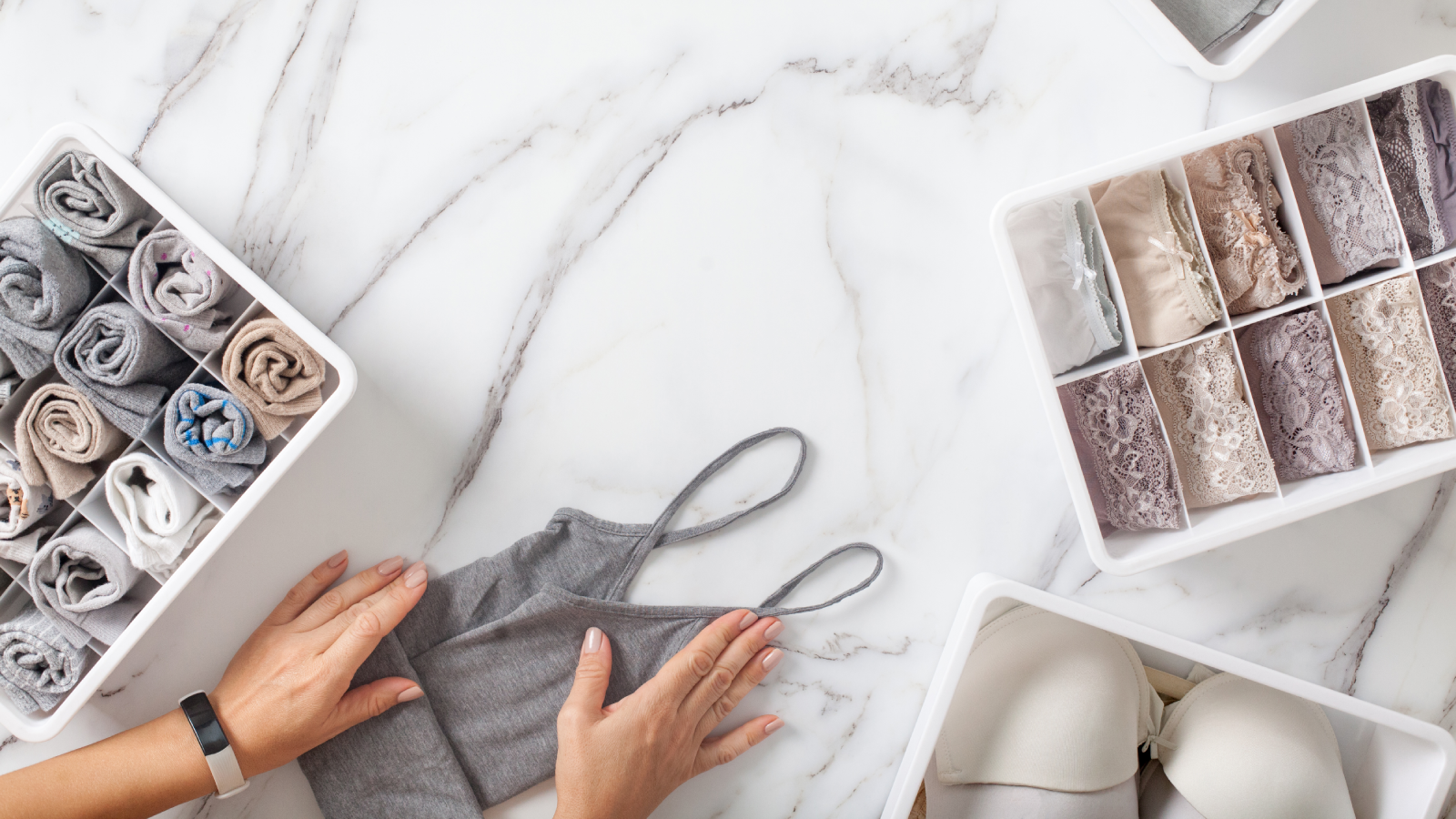 woman organising underwear drawer