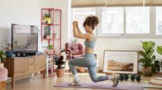 Woman performs lunges on a yoga mat at home