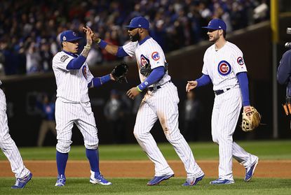 Chicago Cubs players celebrate their win over the Cleveland Indians on Sunday.