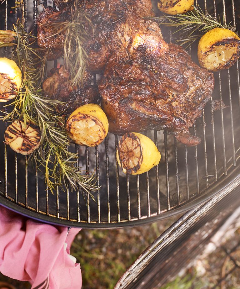 An example of barbecue recipes showing a barbecue with a cooked chicken, lemon halves and rosemary
