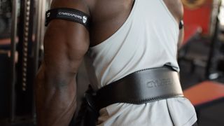 leather vs velcro weightlifting belts: a muscular person wearing a leather lifting belt