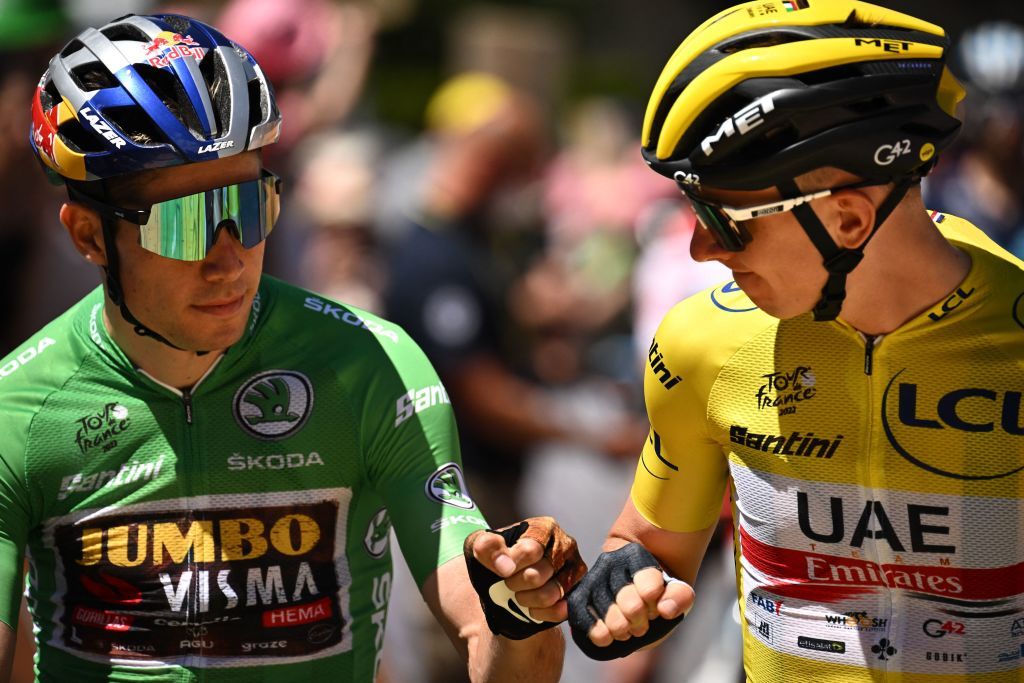 JumboVisma teams Belgian rider Wout Van Aert wearing the sprinters green jersey L fist bumps UAE Team Emirates teams Slovenian rider Tadej Pogacar wearing the overall leaders yellow jersey R as they await the start of the 10th stage of the 109th edition of the Tour de France cycling race 1481 km between Morzine and Megeve in the French Alps on July 12 2022 Photo by Marco BERTORELLO AFP Photo by MARCO BERTORELLOAFP via Getty Images