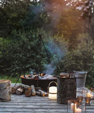 rustic fire pit with lanterns on decking