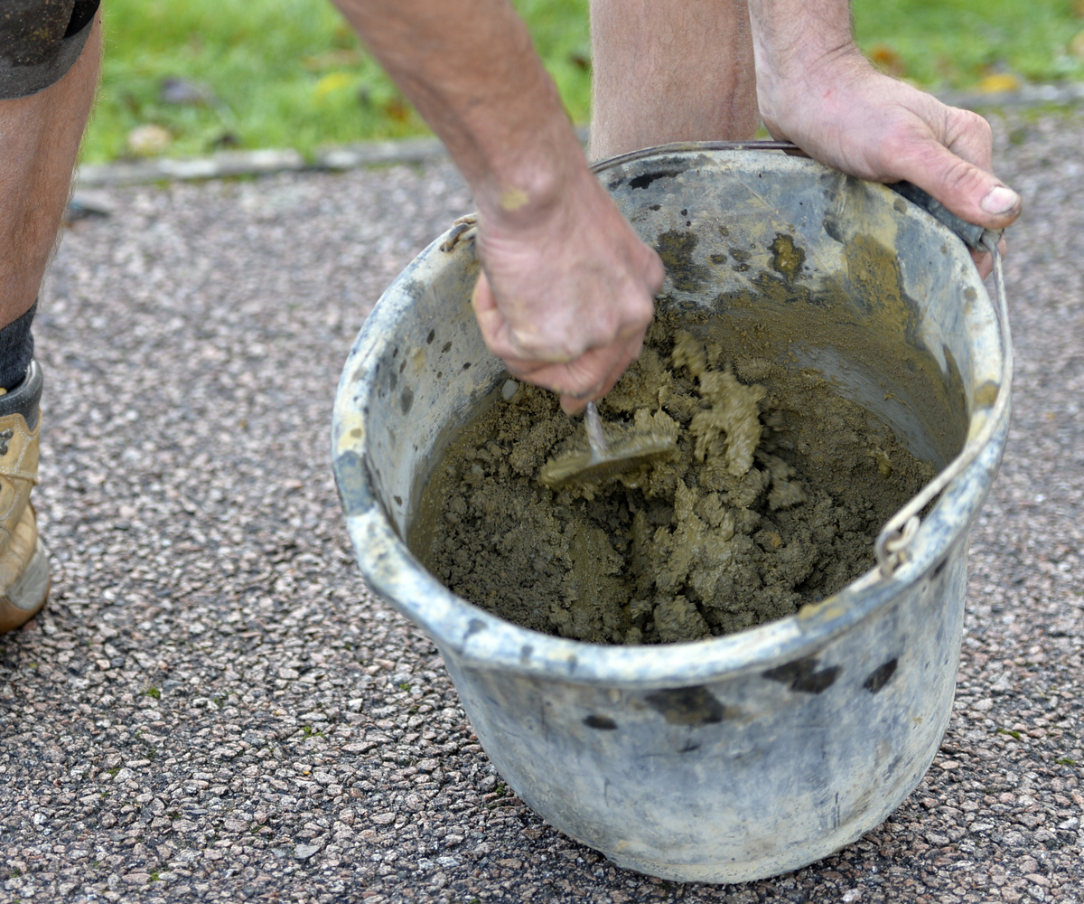 Mortar being mixed in a bucket