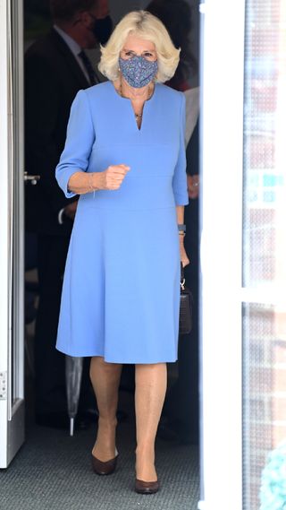 Queen Camilla in a simple blue dress