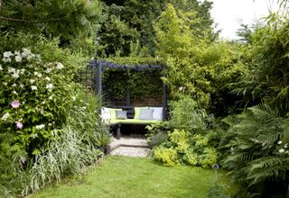 garden privacy ideas: pergola in corner with seating