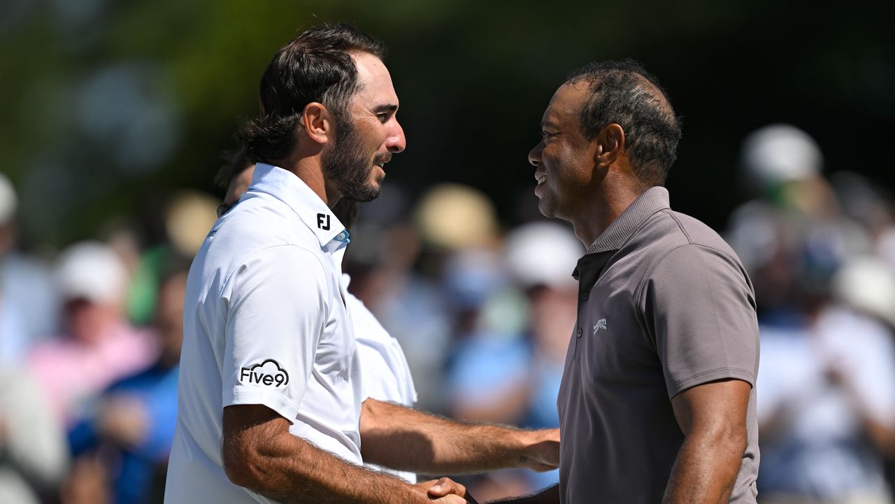 Tiger Woods shakes hands with Max Homa on the 18th green during the second round of the 2024 Masters