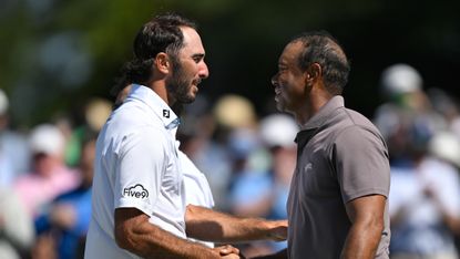 Tiger Woods shakes hands with Max Homa on the 18th green during the second round of the 2024 Masters