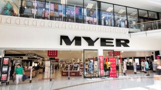 Image of the outside fo a Myer store with red sale signs outside and clothes and cosmetics inside