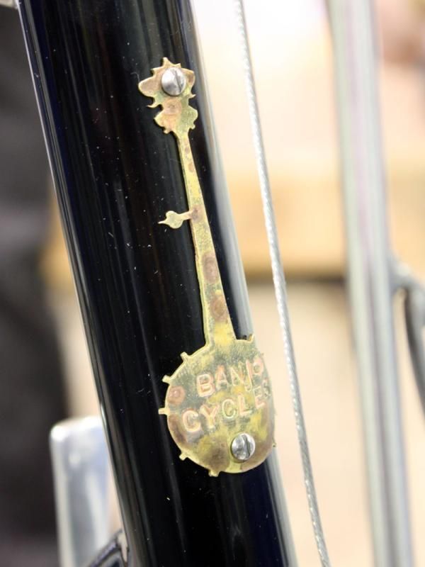 The simple head tube badge contrasts with the amazing level of detail on the bike to which it's affixed.