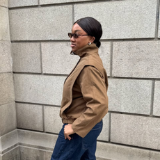 Nnenna in funnel-neck jacket and dark-wash denim