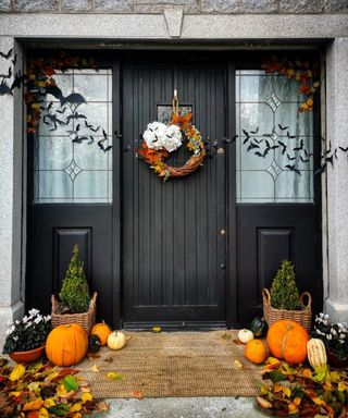 Black and orange halloween door decor with Frenchic chalk painted door and pumpkins purchased from Aldi