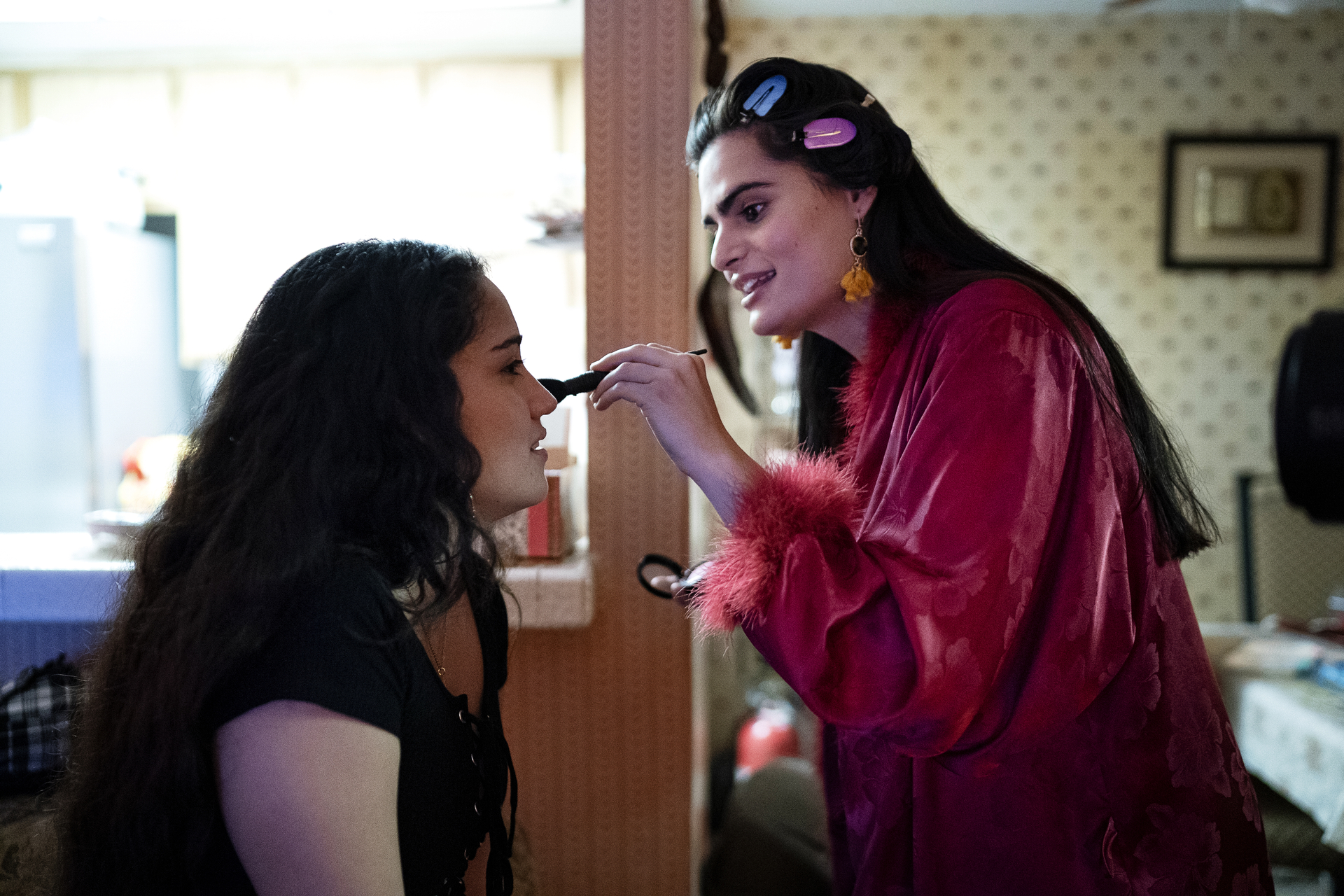 a teen girl (Haley Sanchez as Greta) gets her makeup done by an older woman (Nava Mau as Ana), in 'Genera+ion'