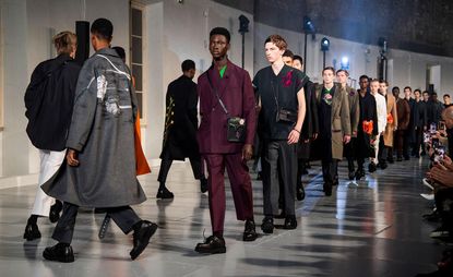 long line of male models on a modeling runway